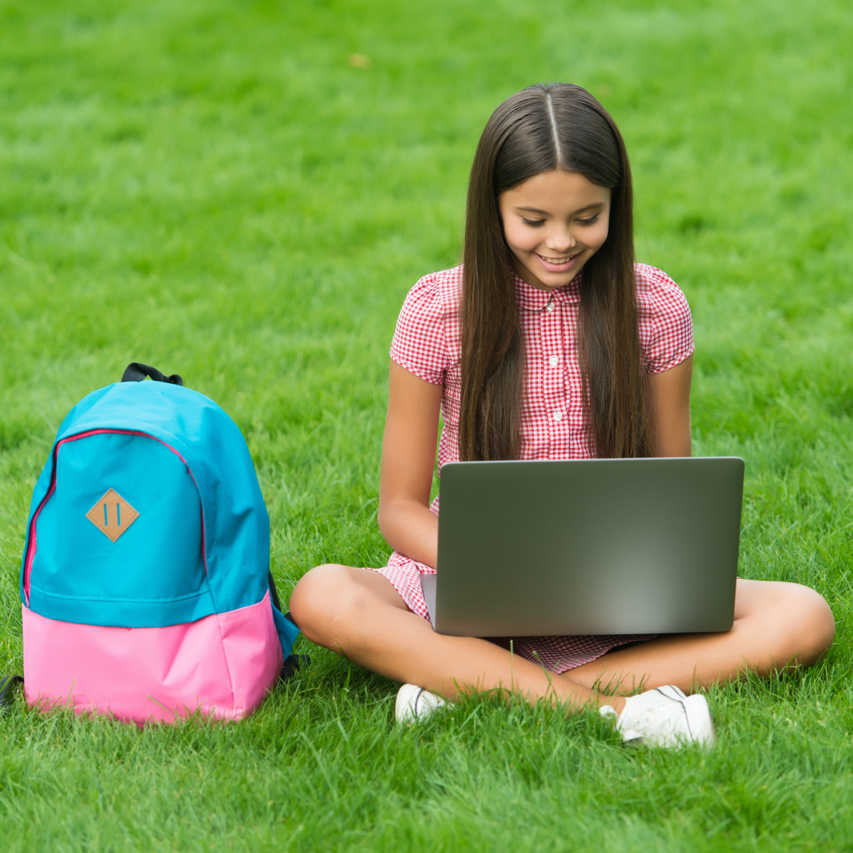 A young girl, between the ages of 1 and 5, is using a laptop.