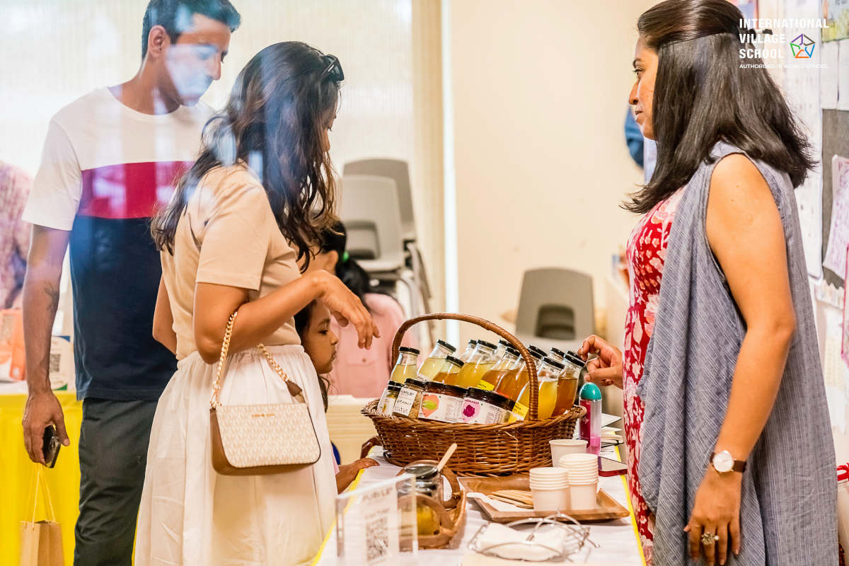 Parents and children visit a stall at an event organized at the International Village School.