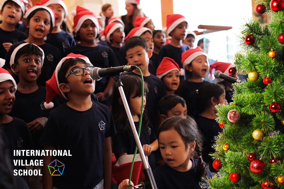 A group of children joyfully singing Christmas carols.