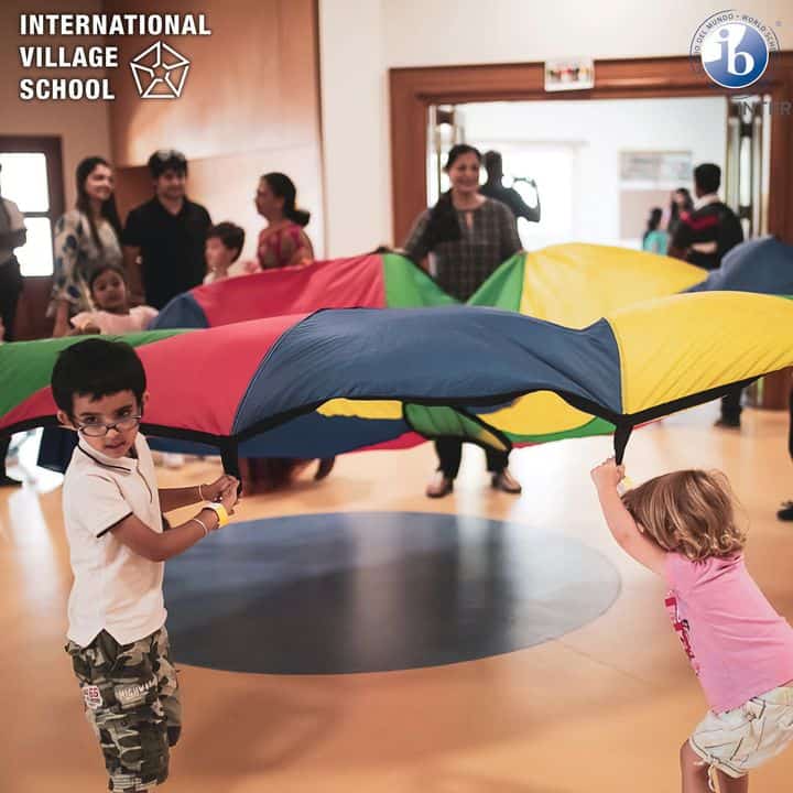 Children playing with teachers in the school premises.
