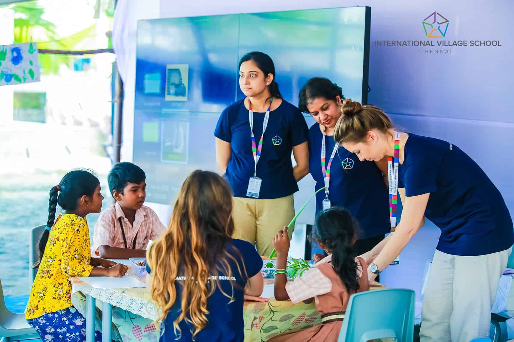 Teachers of IVS interacting with small children.